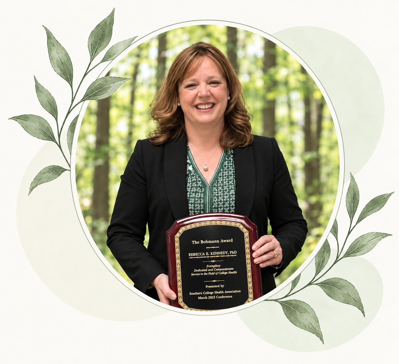 A woman in a black blazer holding a plaque that reads, "The Bohmann Award, Rebecca E. Kennedy, PhD, Exemplary Dedicated and Compassionate Service to the Field of College Health, Presented by Southern College Health Association, March 2023 Conference," standing outdoors with a background of green trees.