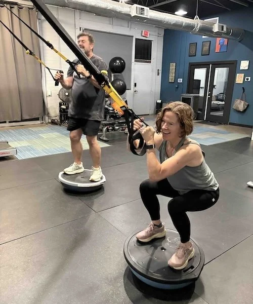 Couple, male and female, working out in Blackbird gym