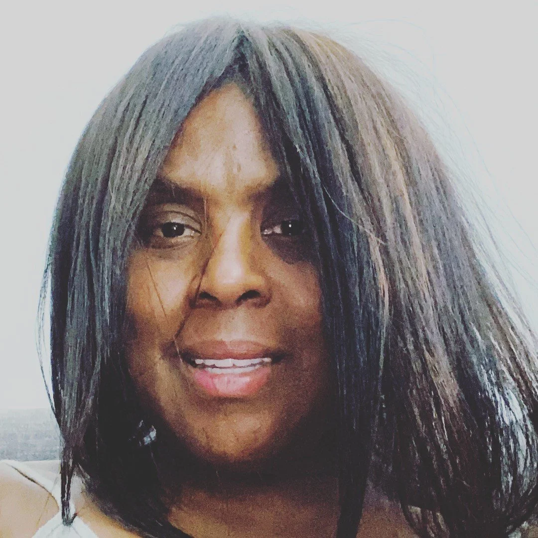 A woman with straight, dark hair and a smile, facing the camera.