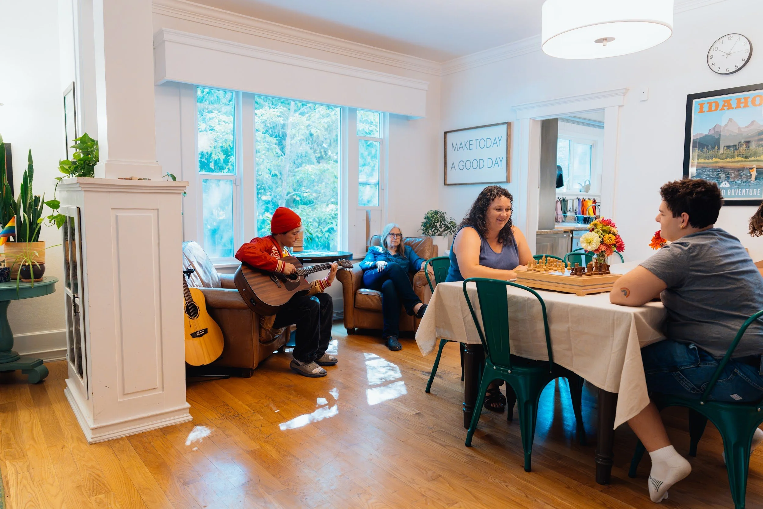 Young adults playing chess at a dining table