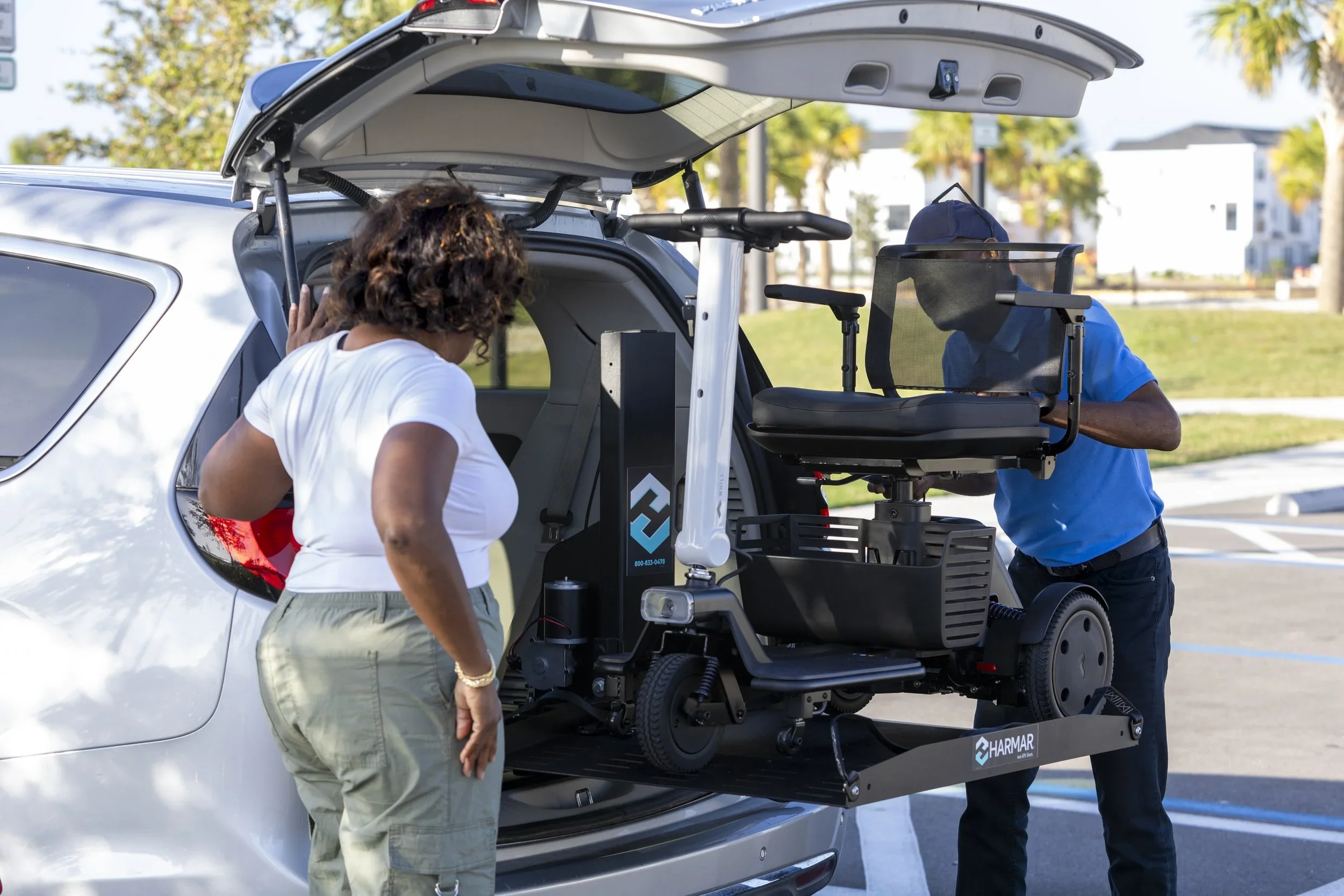 Mobility scooter being loaded into an SUV using a vehicle mobility lift.