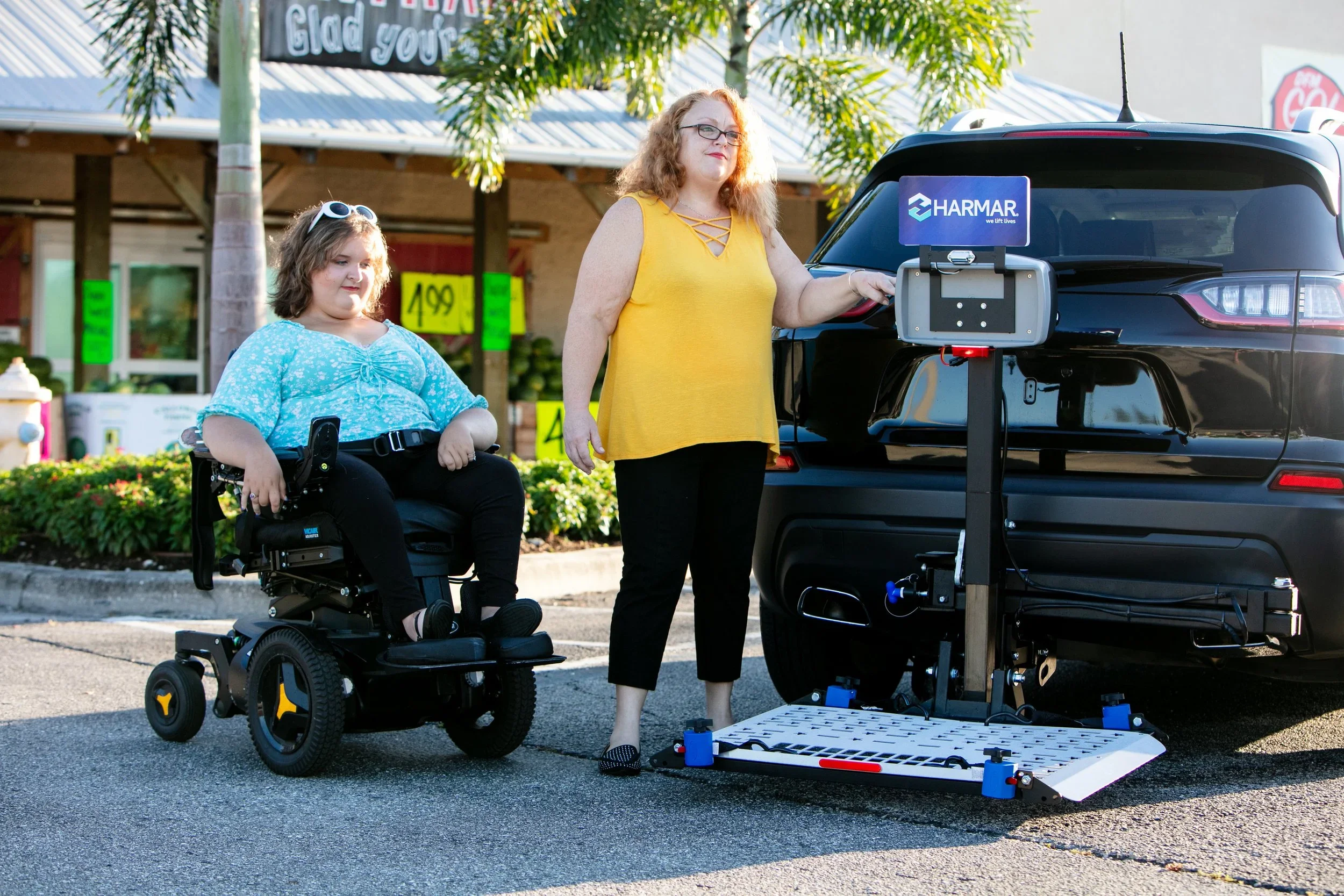 Mobility scooter being loaded into an SUV using a vehicle mobility lift.