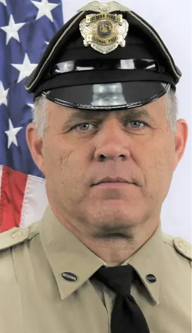 Detective Mark Baker posing in uniform