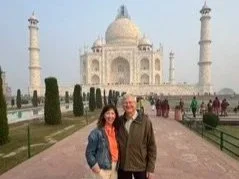 A couple standing in front of the Taj Mahal in Agra, India.