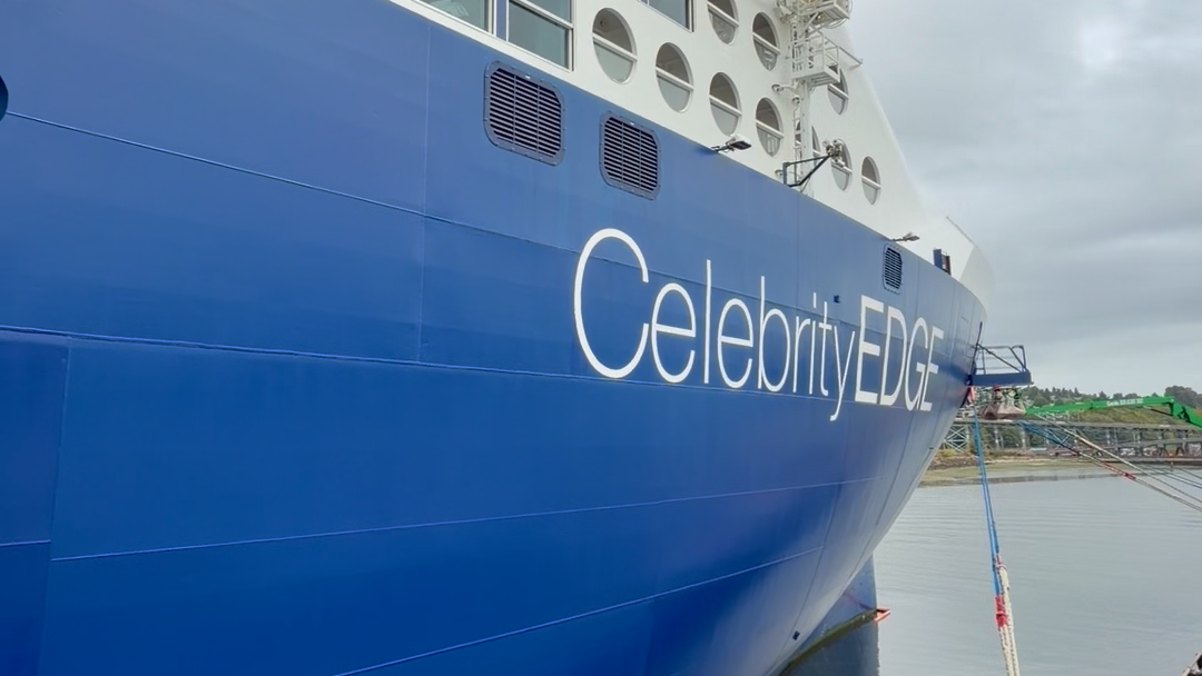 Close view of the blue hull of Celebrity Edge while the ship is docked.