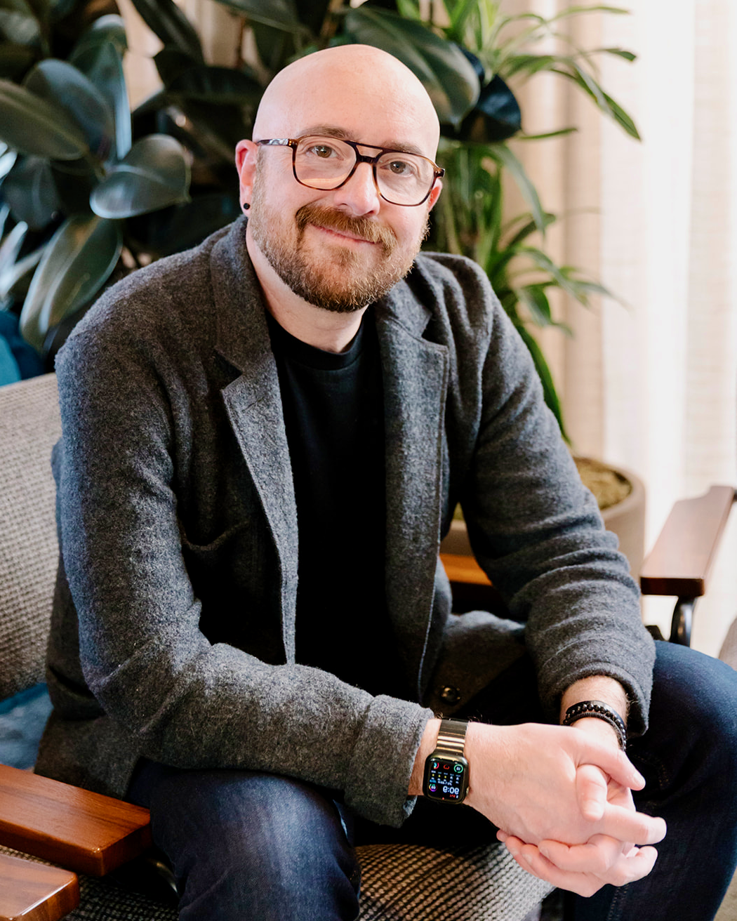 1. Travel advisor seated indoors, smiling at the camera.
