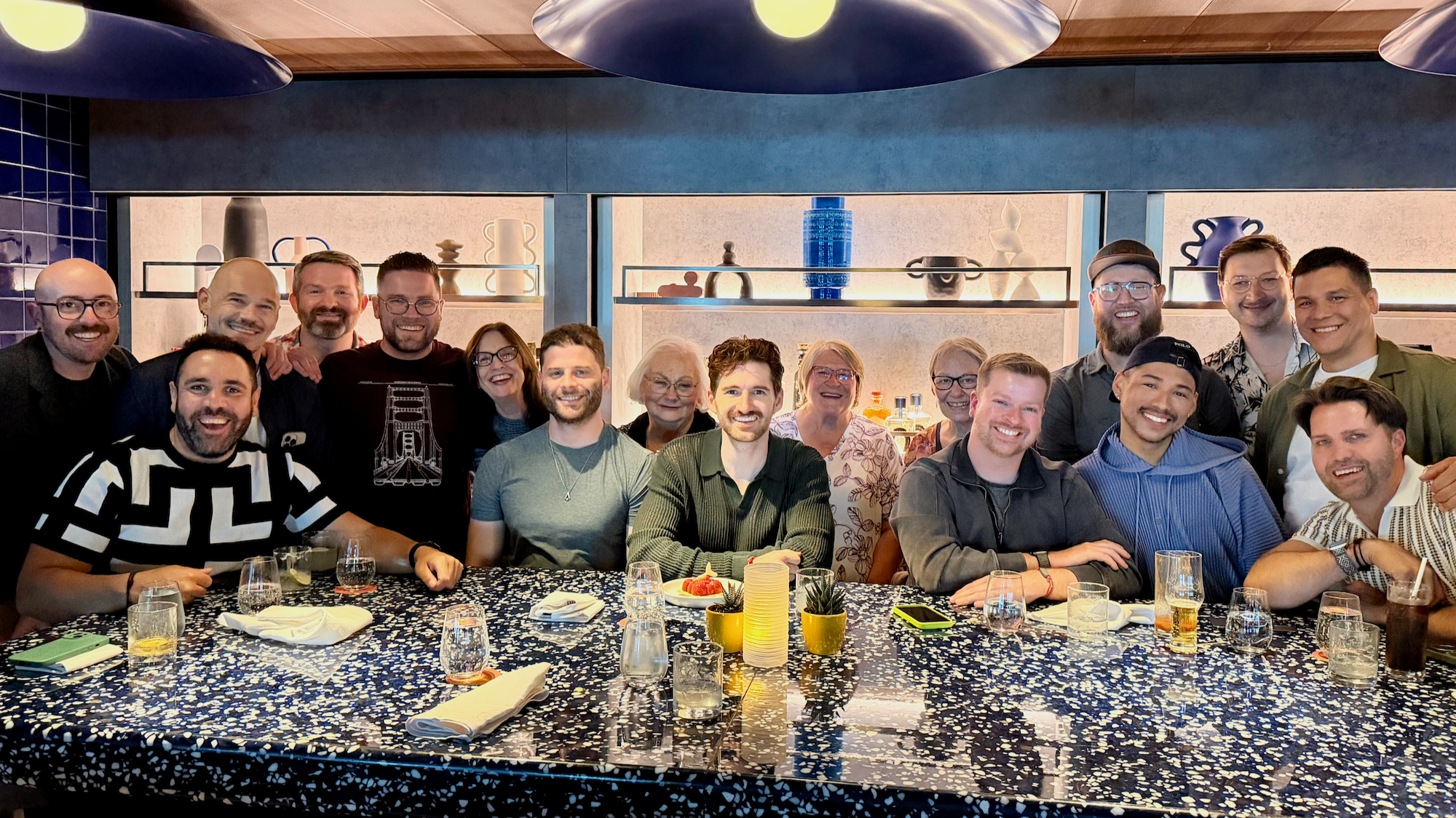 1. A large group of friends gathered around a restaurant table for dinner.