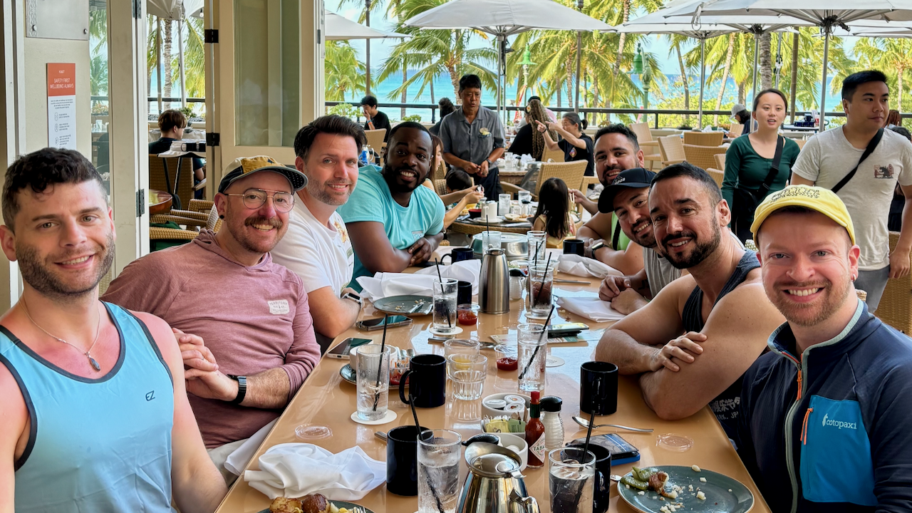 a group of travelers at a sunny breakfast table in Honolulu