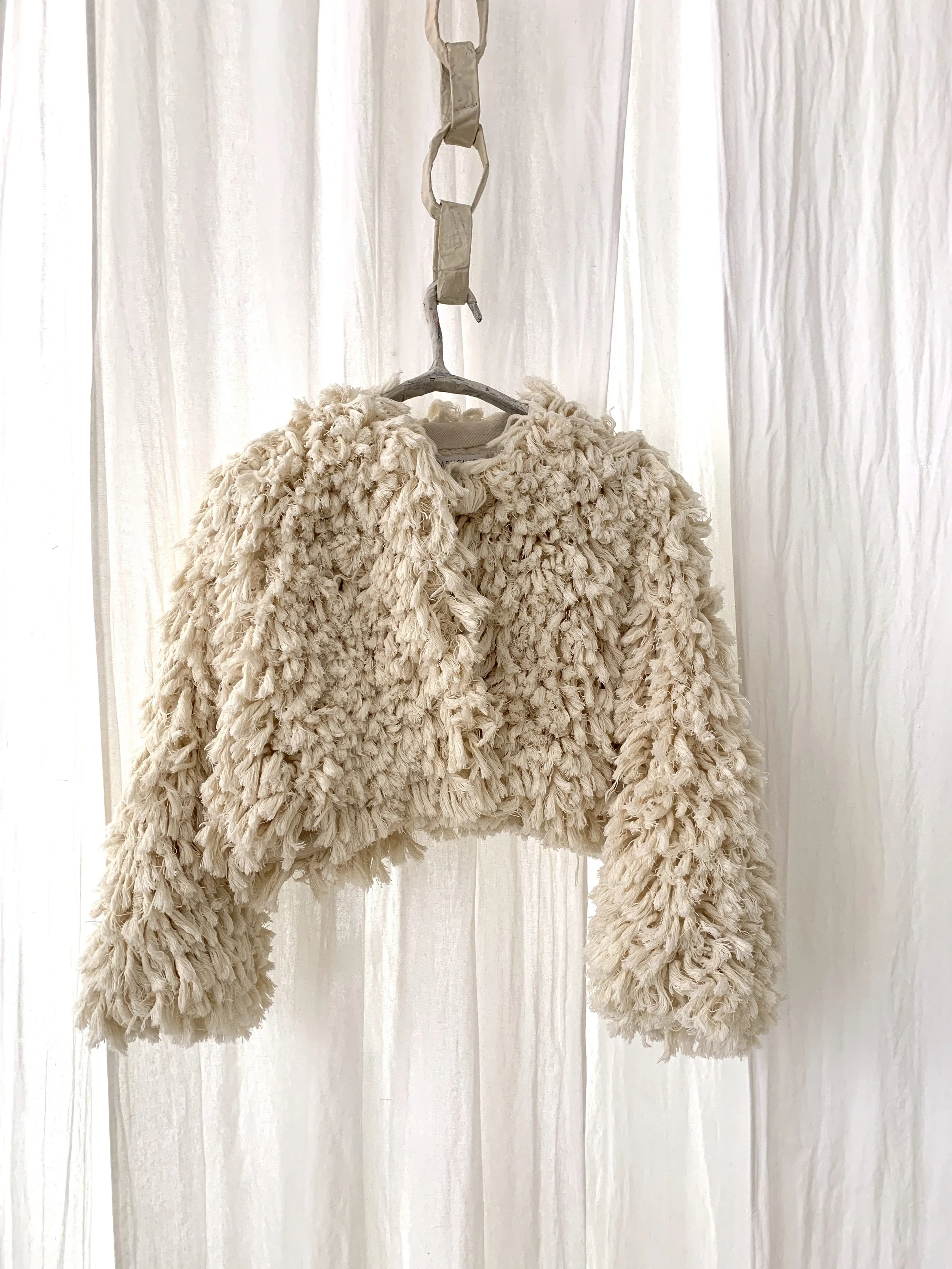 Mexchic Shag throw pillow, rug, jacket, purse texture handwoven in cream cotton, artisan made textile in Clothing craft shopping in Oaxaca Mexico. The Mexican textile is made with handwoven cotton made on a loom. Moroccan wedding blanket loops beddin