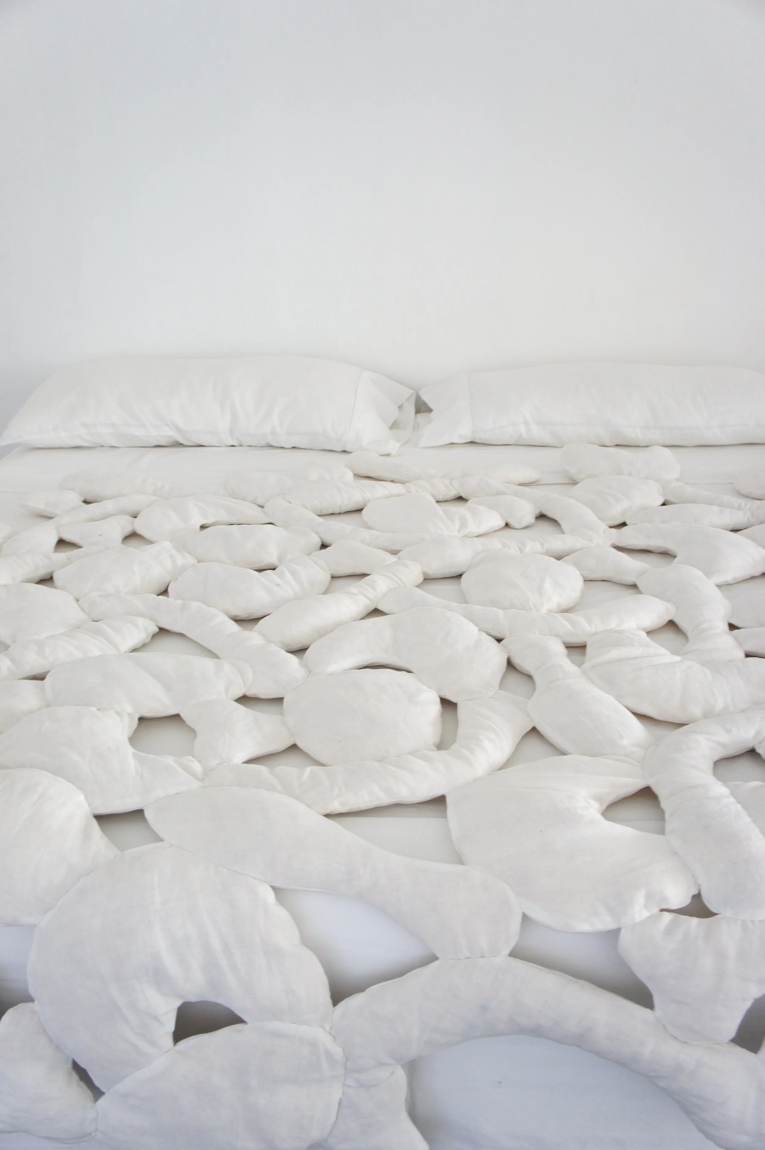 Mexchic soft sculpture mexchic pillow bones huesitos three dimensional 3-D quilt oaxaca mexico christina hattler contemporary craft art artisanal textile handmade hand sewn linen ceiba pochote kapok fiber artist 