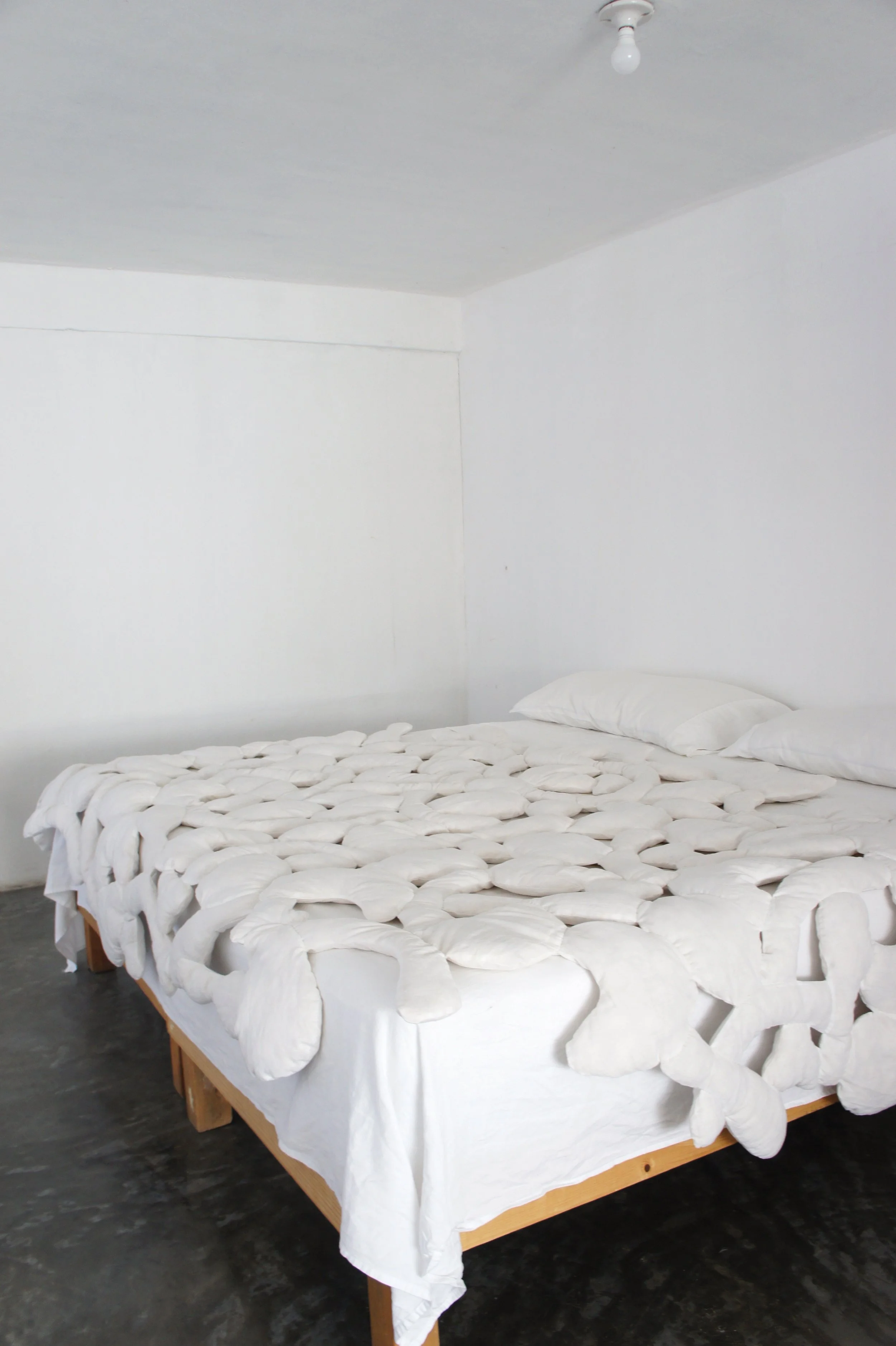 Mexchic soft sculpture mexchic pillow bones huesitos three dimensional 3-D quilt oaxaca mexico christina hattler contemporary craft art artisanal textile handmade hand sewn linen ceiba pochote kapok fiber artist 