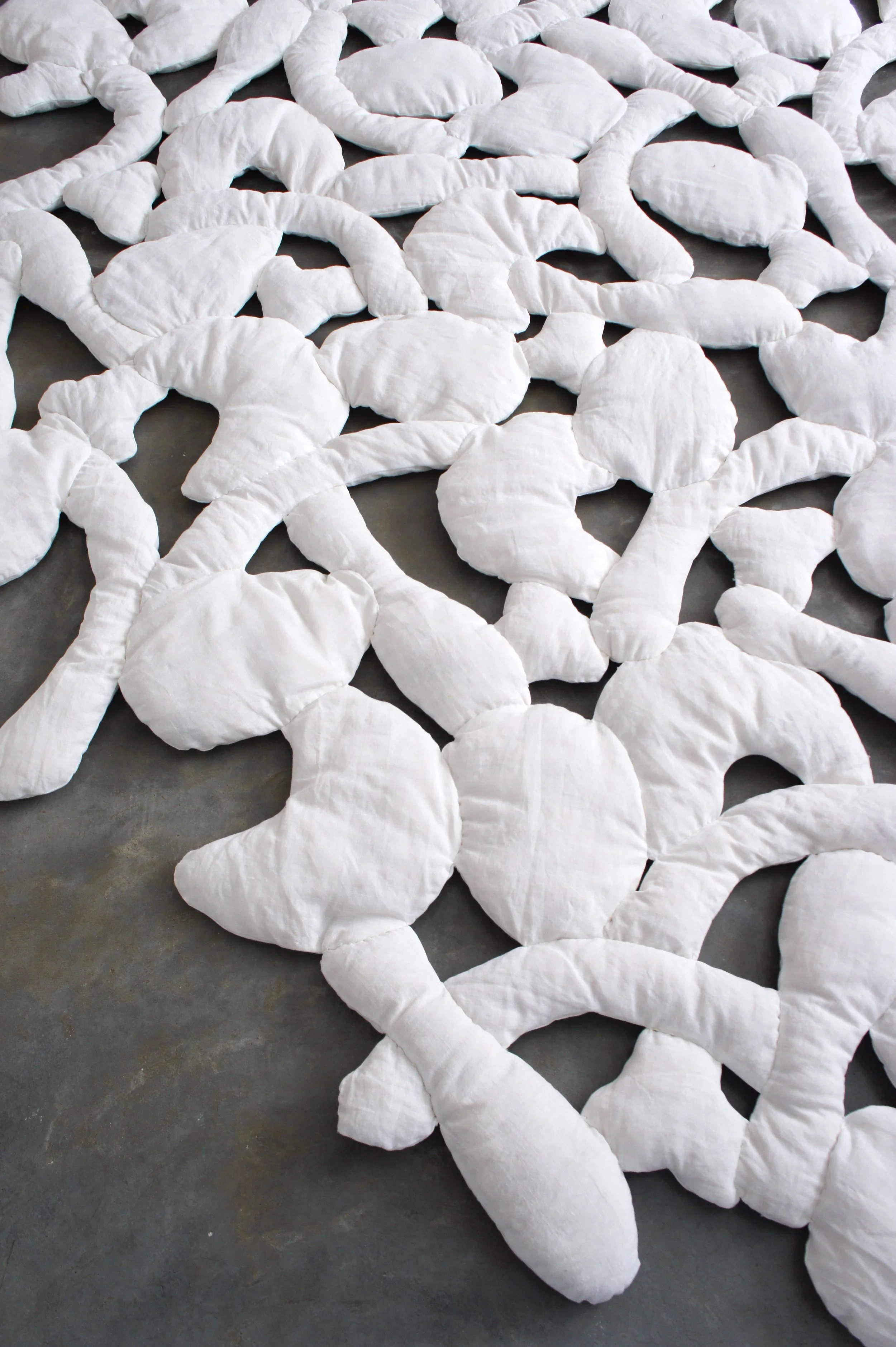 Mexchic soft sculpture mexchic pillow bones huesitos three dimensional 3-D quilt oaxaca mexico christina hattler contemporary craft art artisanal textile handmade hand sewn linen ceiba pochote kapok fiber artist 
