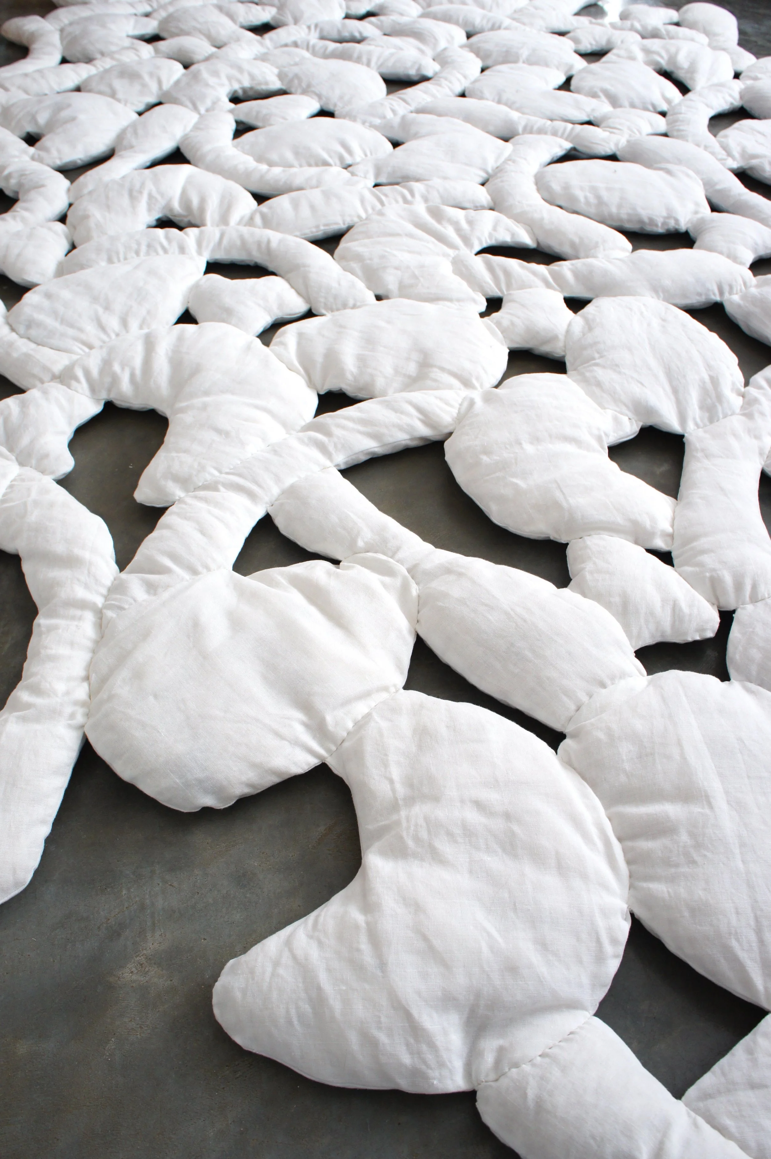 Mexchic soft sculpture mexchic pillow bones huesitos three dimensional 3-D quilt oaxaca mexico christina hattler contemporary craft art artisanal textile handmade hand sewn linen ceiba pochote kapok fiber artist 
