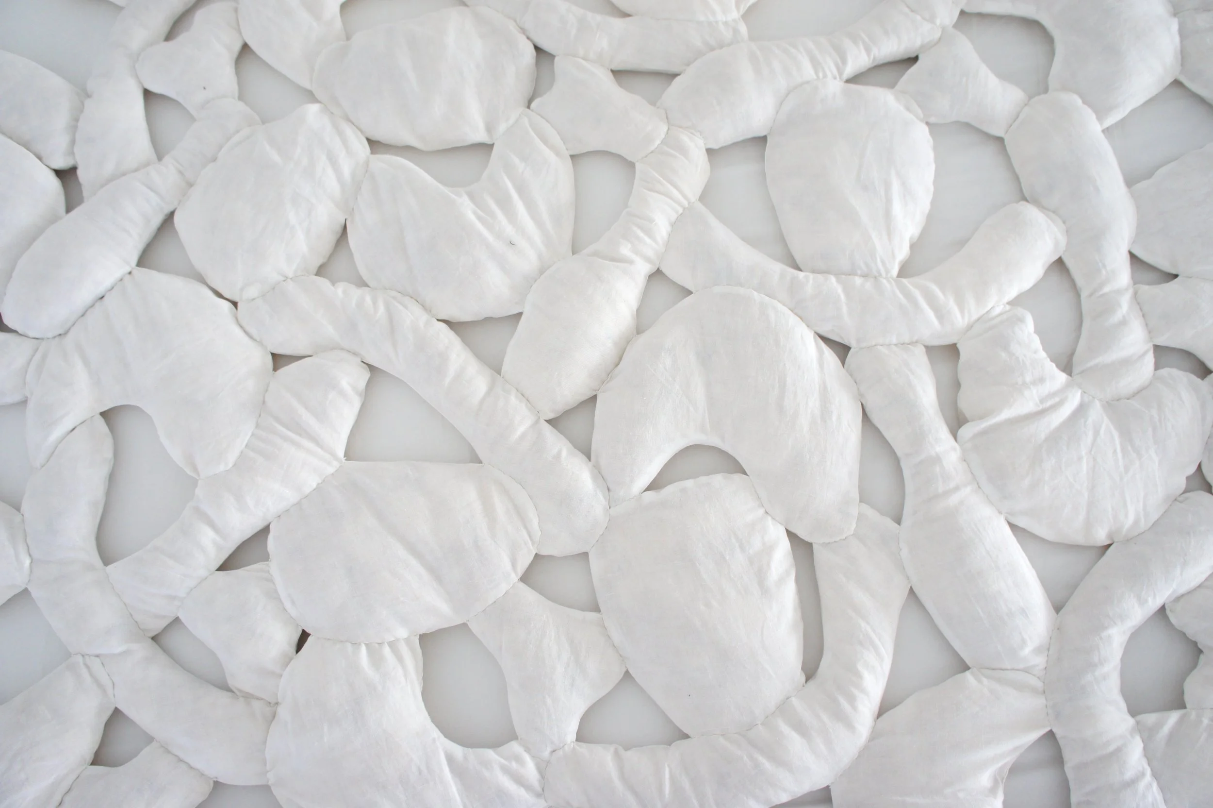 Mexchic soft sculpture mexchic pillow bones huesitos three dimensional 3-D quilt oaxaca mexico christina hattler contemporary craft art artisanal textile handmade hand sewn linen ceiba pochote kapok fiber artist 