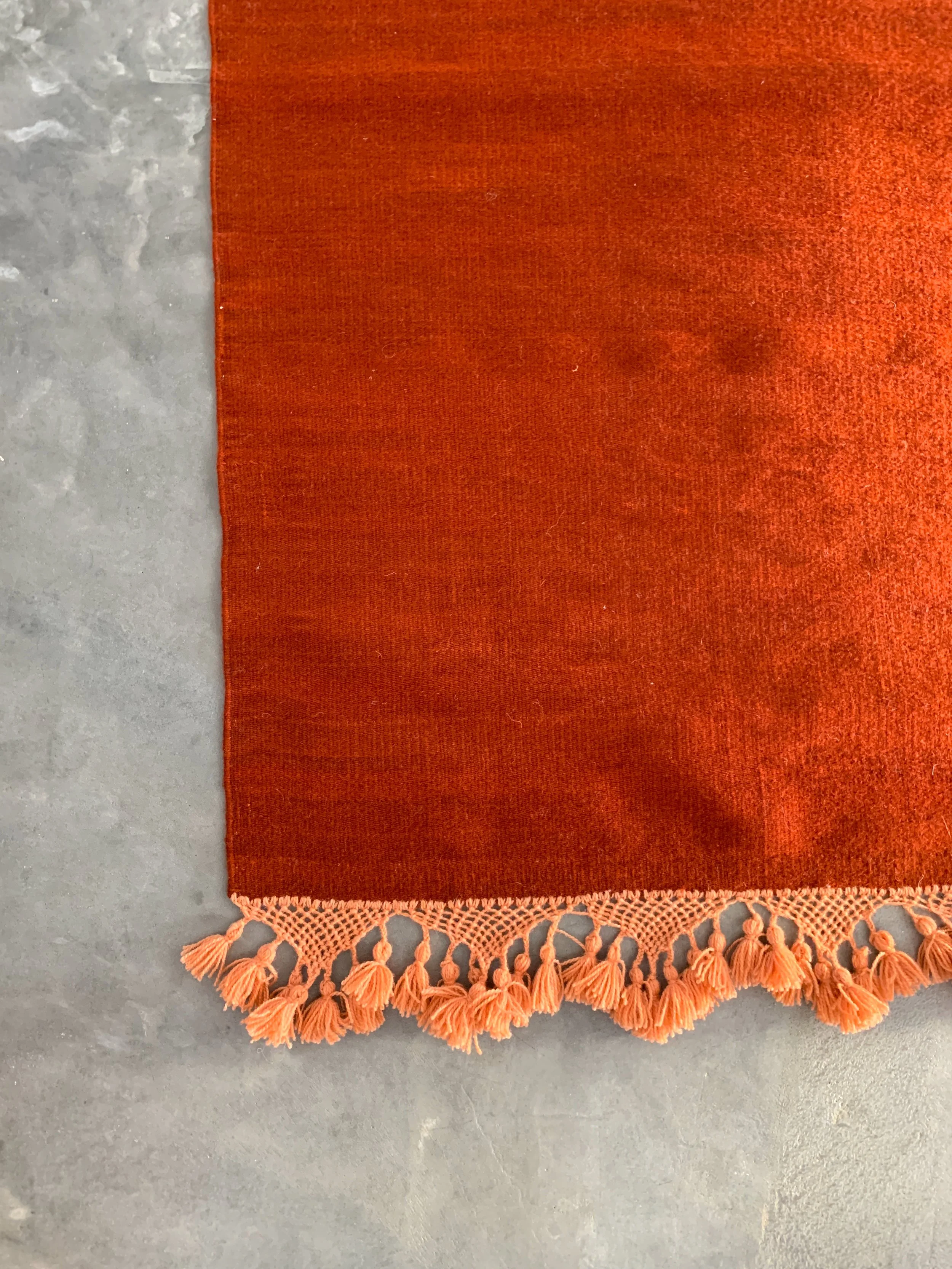 hand woven rug rugs oaxaca teotitlan del valle oaxaca mexico mexican fringe macrame hand knotted pom pom merino wool argentinian wool high quality home goods luxury artisan craft natural dyes botanically dyed hand dyed melon pink peach pink red ochre