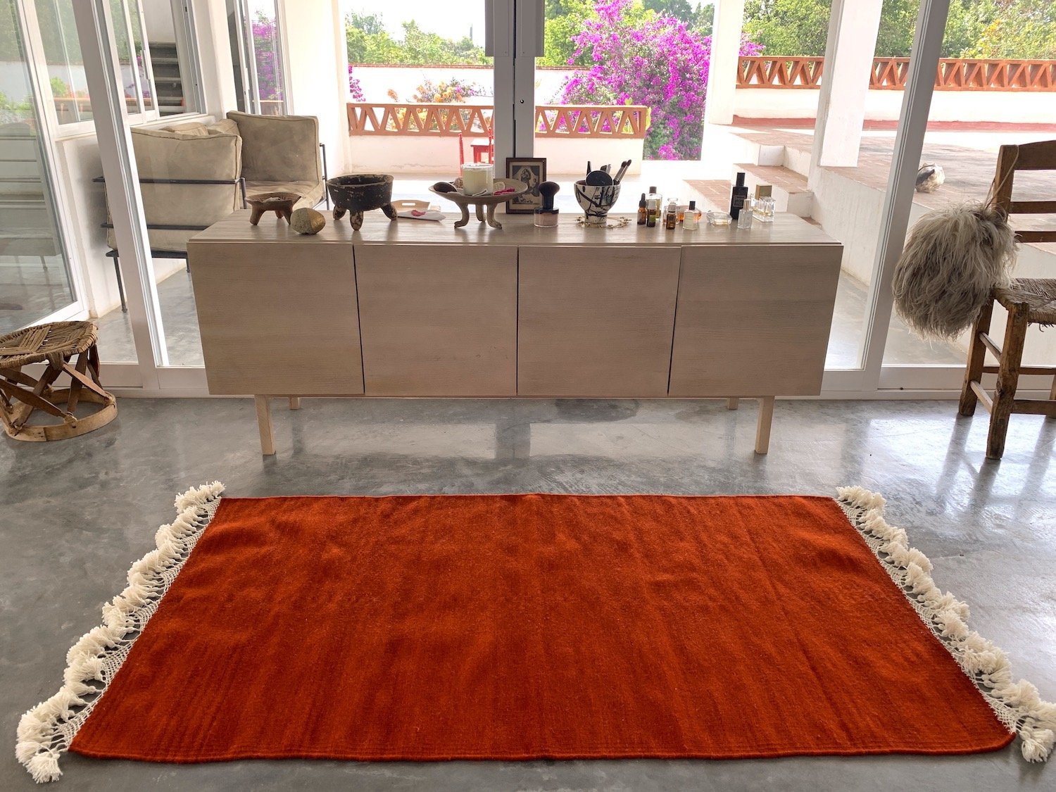 hand woven rug rugs oaxaca teotitlan del valle oaxaca mexico mexican fringe macrame hand knotted pom pom merino wool argentinian wool high quality home goods luxury artisan craft natural dyes botanically dyed hand dyed melon pink peach pink red ochre