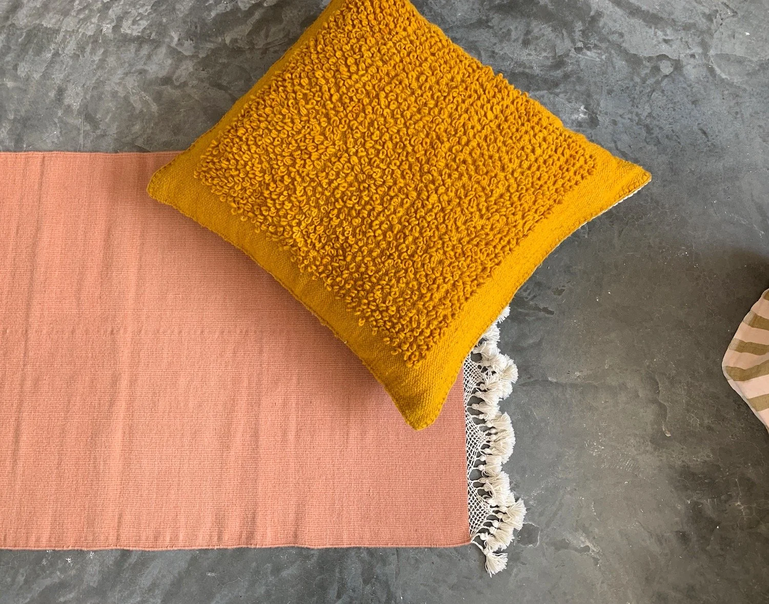 hand woven rug rugs oaxaca teotitlan del valle oaxaca mexico mexican fringe macrame hand knotted pom pom merino wool argentinian wool high quality home goods luxury artisan craft natural dyes botanically dyed hand dyed melon pink peach pink red ochre
