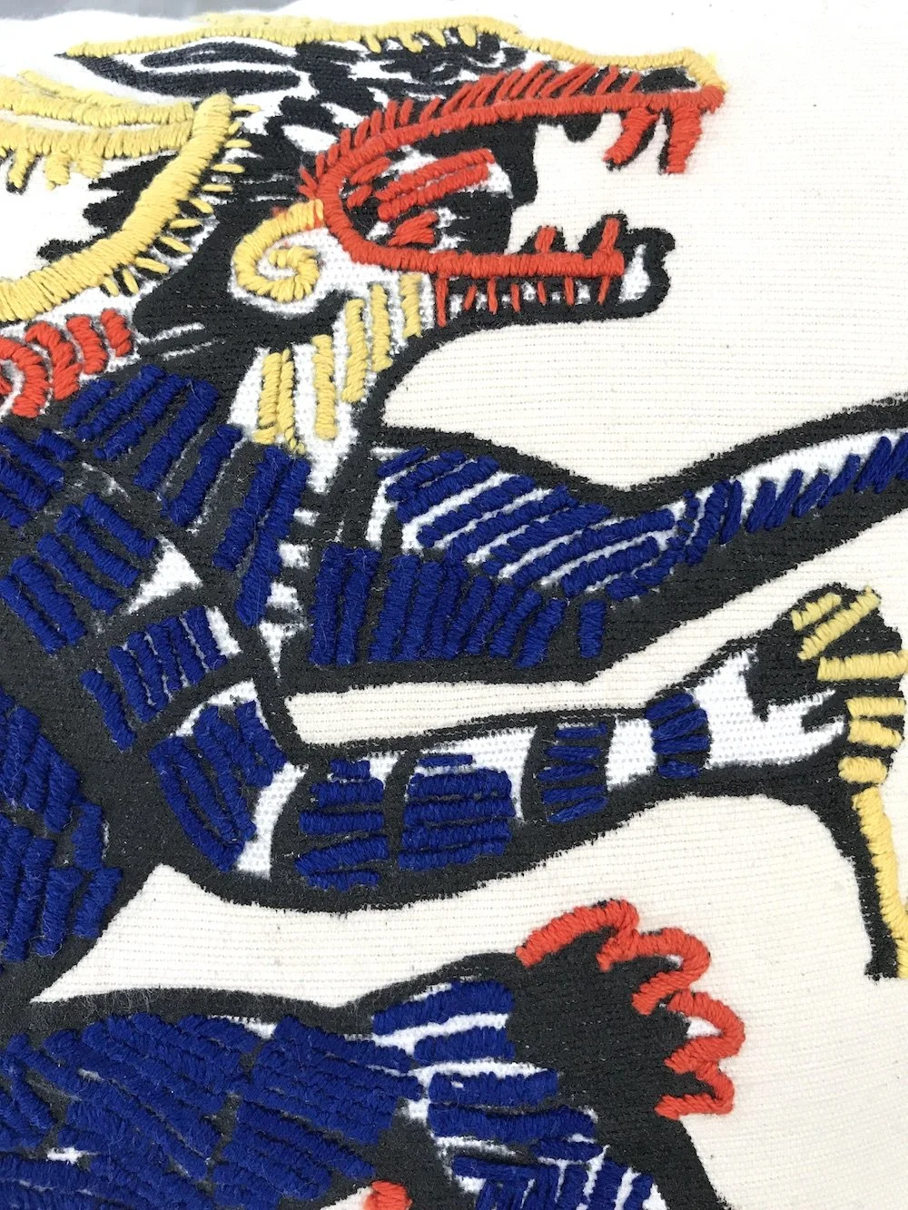 hand embroidered pillow throw decorative oaxaca mexico embroidery silk screen artist aztec miguel hernandez malinalco painter mexchic orange yellow pink purple blue green eagle deer lobo wolf iconography contemporary design designer  