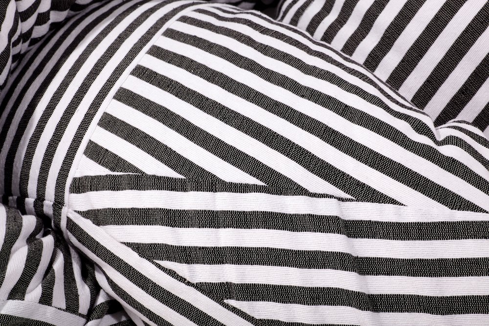 Mexchic Quetzalcoatl handwoven cotton pillow serpent snake seat chair oaxaca  mexchic wool contemporary design aztec pop culture soft sculpture Sol Lewitt linear black and white stripe