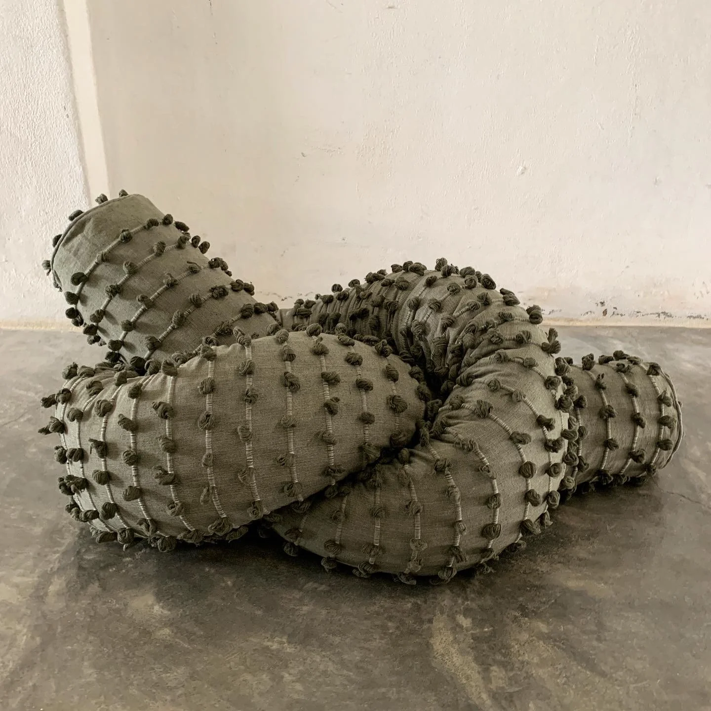 Mexchic Quetzalcoatl handwoven cotton pillow serpent snake seat chair oaxaca  mexchic wool contemporary design aztec pop culture soft sculpture texture agave green puffs 