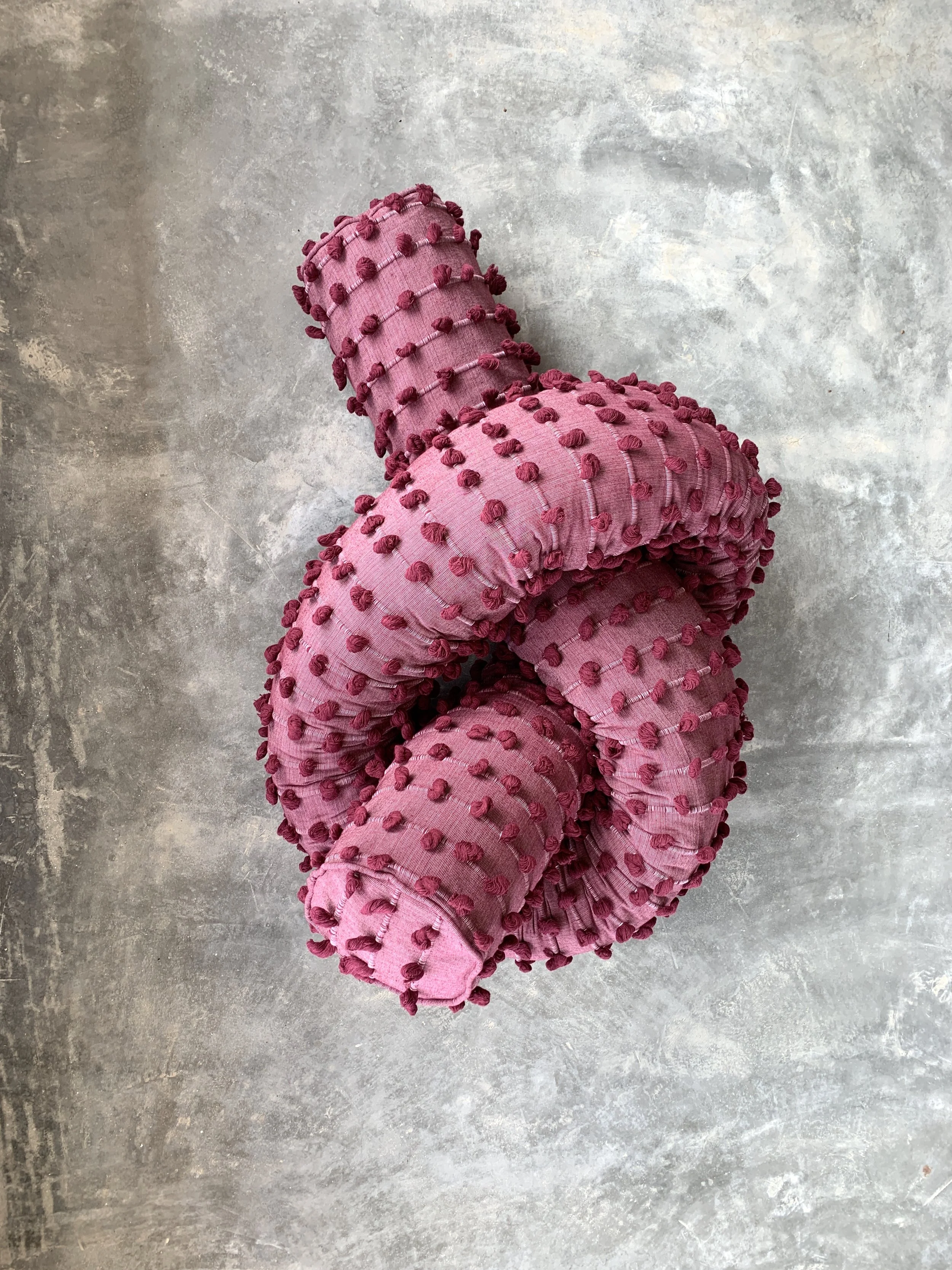 Mexchic Quetzalcoatl handwoven cotton pillow serpent snake seat chair oaxaca  mexchic wool contemporary design aztec pop culture soft sculpture texture red wive burgundy puffs 