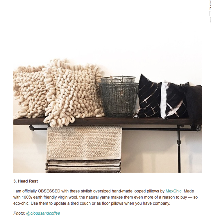Decorative shelf displaying chunky cream knit pillow, black wire basket, and black and white striped cloth along with a hanging beige textured towel or blanket.