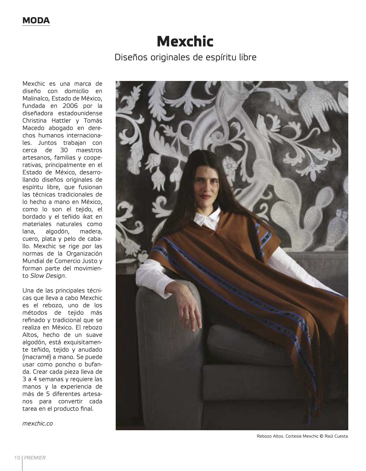 A woman with long dark hair sitting on a gray armchair, wearing a traditional Mexican rebozo, in front of a black and white mural with floral and animal motifs.