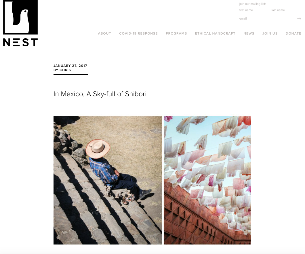 A website page with the NEST logo at the top left, a navigation menu, and two photos. The left photo shows a man sitting on stone steps with a sun hat, plaid shirt, and dark pants. The right photo shows clothes hanging on strings against a bright blu