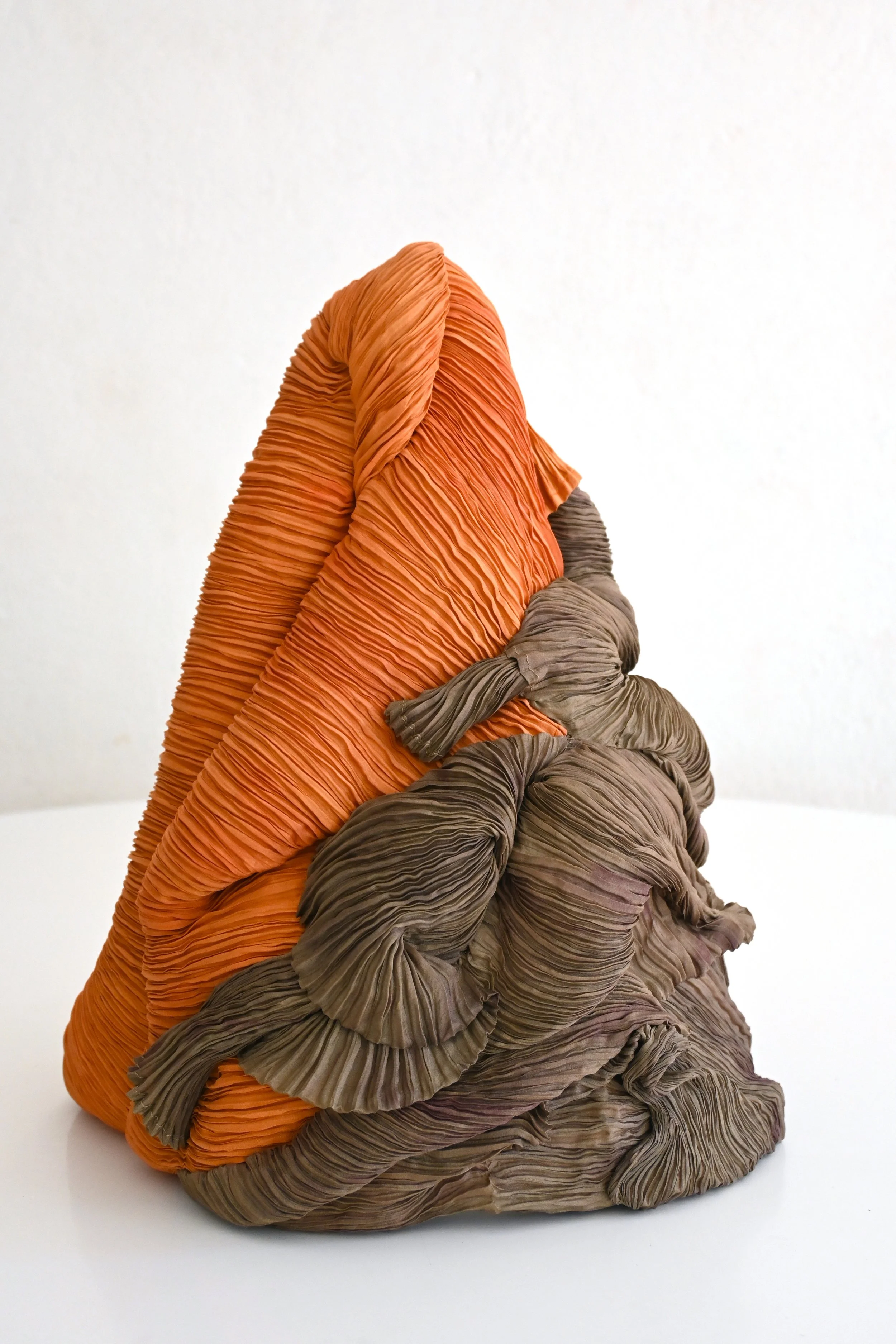 Colorful textured sculpture resembling organ-like organic shapes with orange and brown hues.