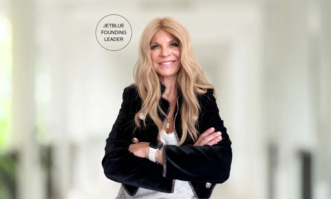Frankie Littleford, JetBlue founding leader, standing with arms crossed in a black blazer.