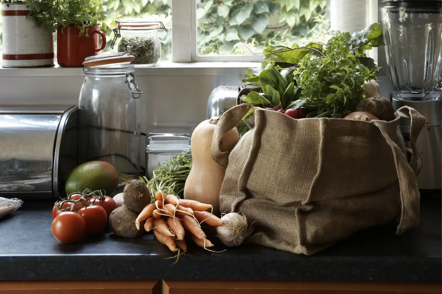Fresh groceries in a reusable bag on a kitchen counter, ready to put away