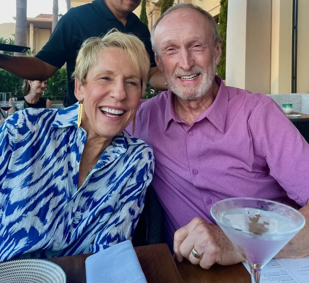 Christin’s parents smiling together over dinner, the inspiration behind Bend Senior Concierge