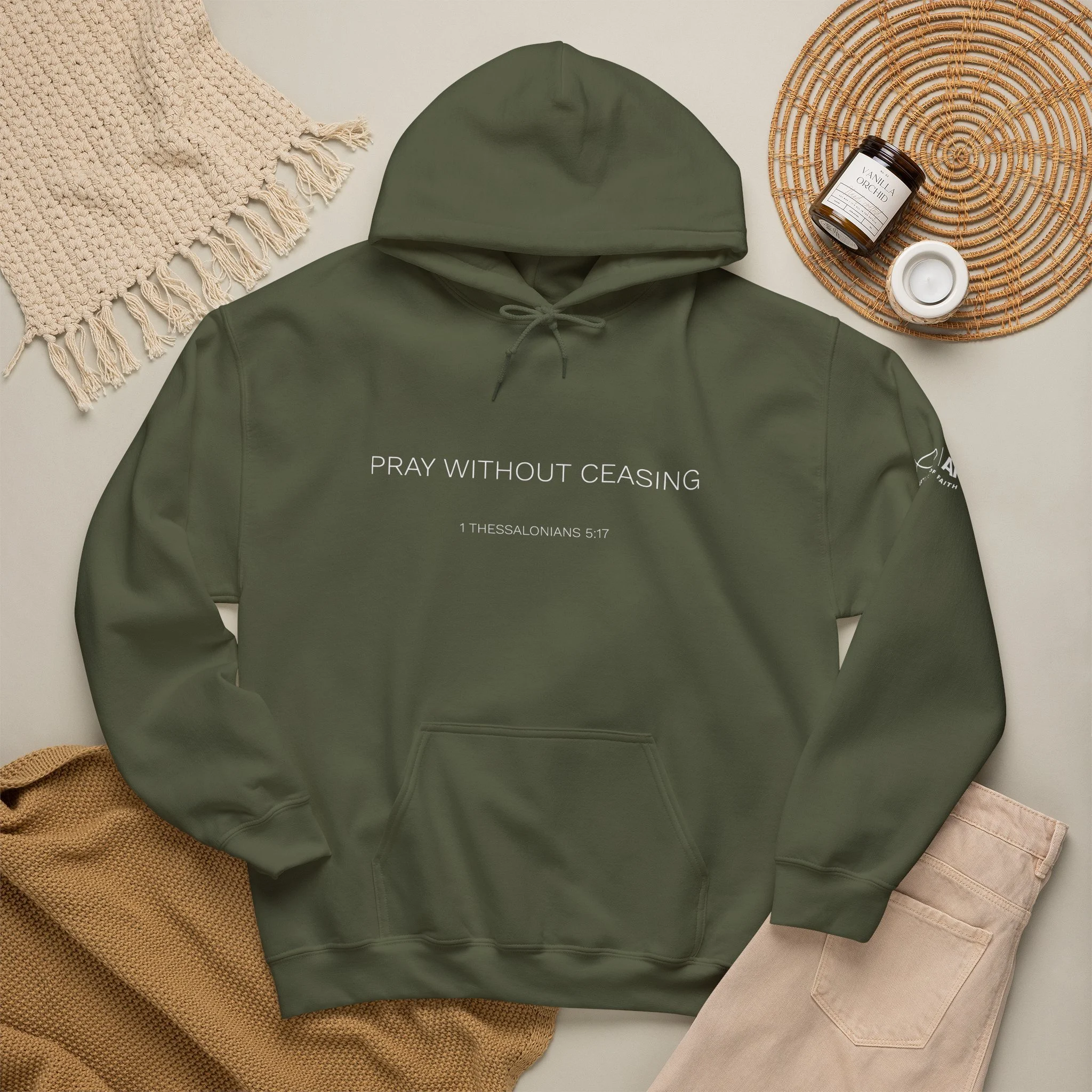 Lifestyle flat lay featuring Articles of Faith Scripture-inspired apparel with PRAY WITHOUT CEASING on the front.