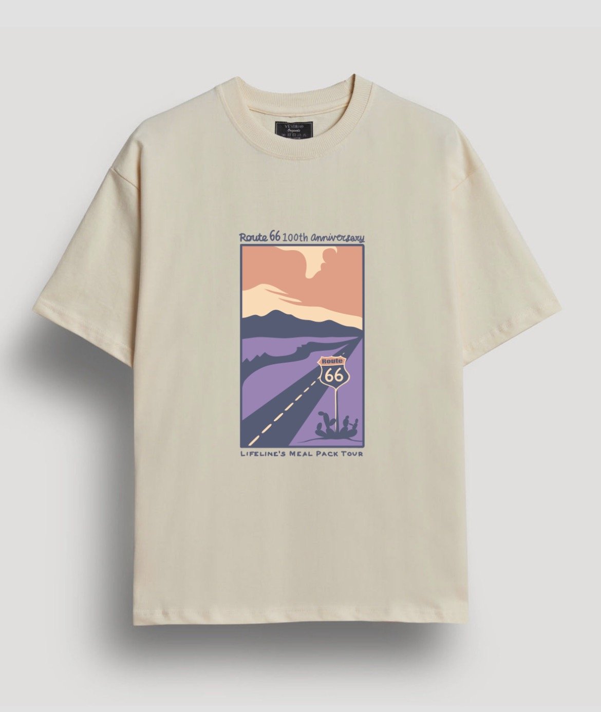Cream-colored T-shirt featuring a graphic of a stylized landscape with a sunset or sunrise, mountains, and road sign for Route 66. Text on the shirt reads 'Route 66 100th anniversary' and 'Lifeline's Meal Pack Tour.'