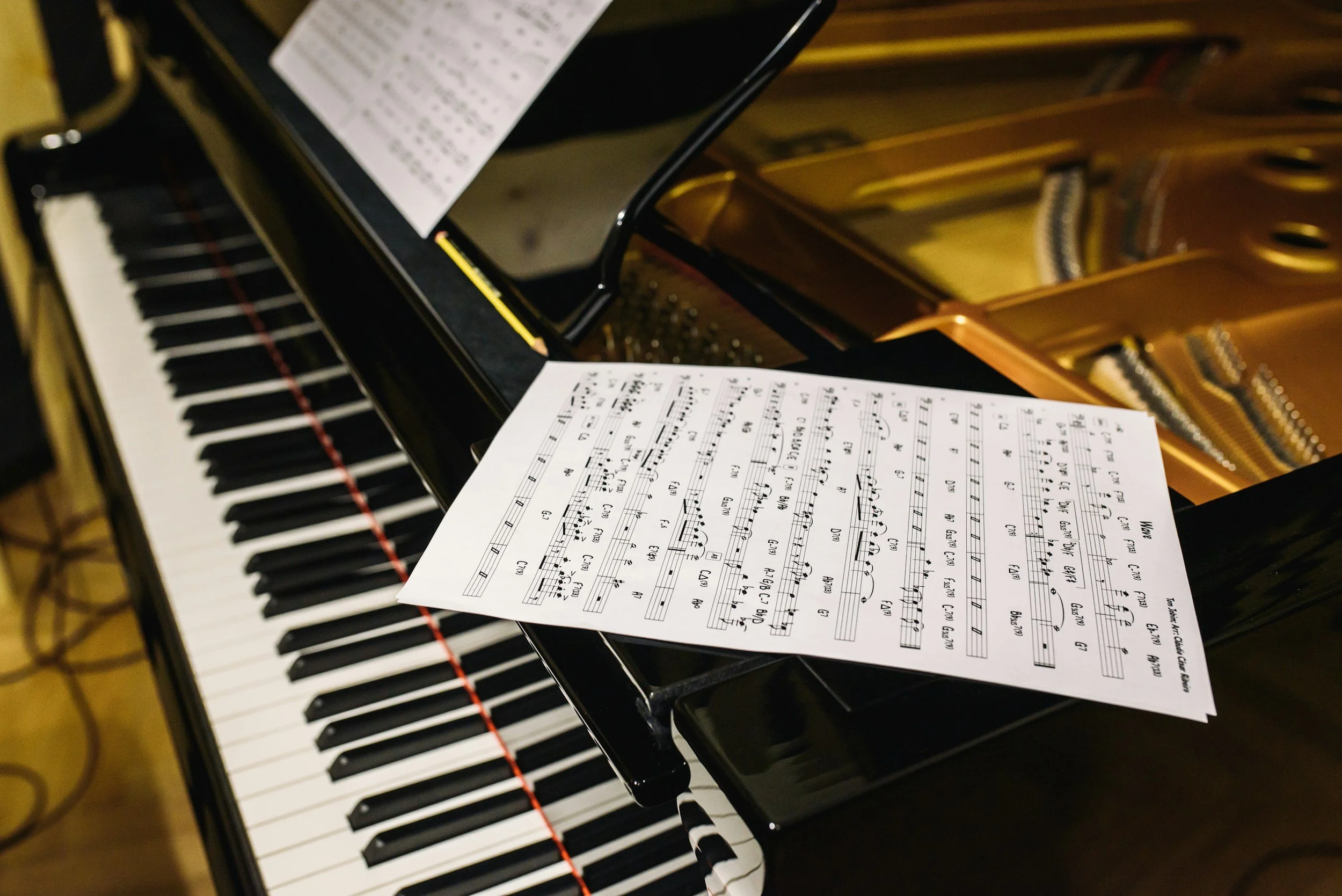 Close-up of a grand piano with sheet music placed on the music stand.
