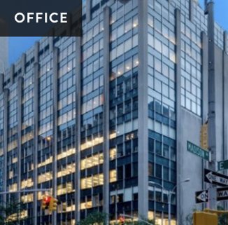 Modern office building with glass windows in an urban setting.