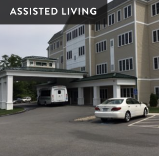 Assisted living facility with parking lot including an ambulance and a white car