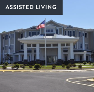 Assisted living facility with a flagpole in front, and a sign indicating assisted living.