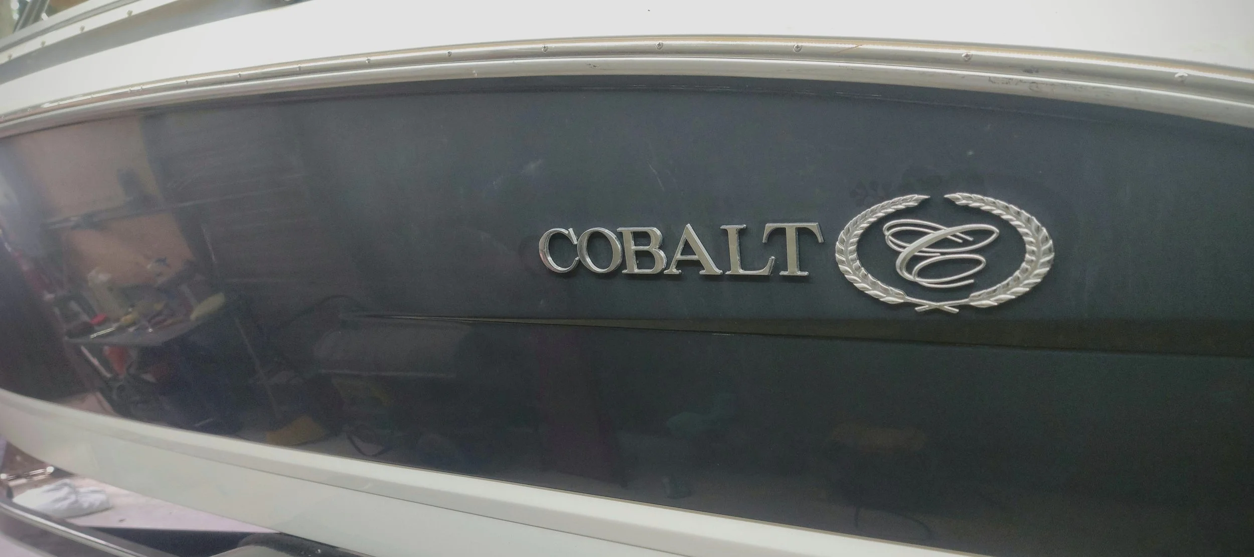 Close-up of a classic Cobalt vehicle badge with the word "COBALT" and a silver laurel emblem.