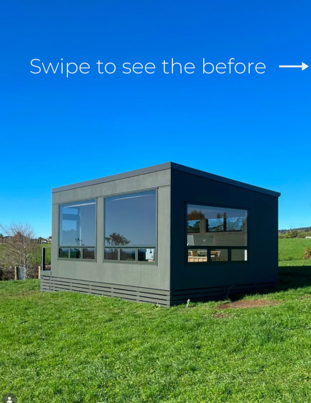 A small, modern, gray building with large windows sits on a grassy field under a clear blue sky. The image contains a 'Swipe to see the before' message with an arrow pointing to the right. Natural Paint Company. Awhina Painters.