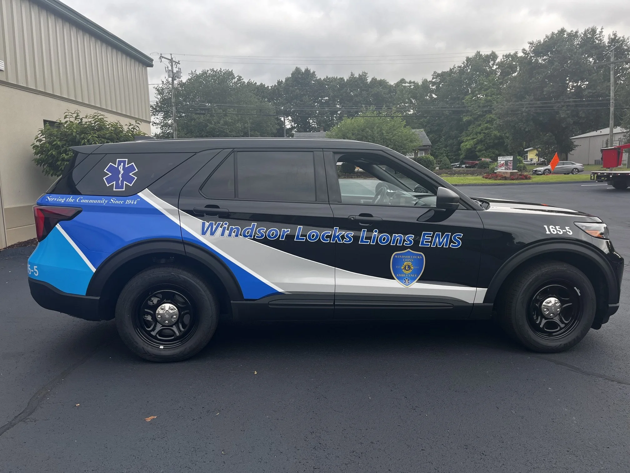 Partial custom wrap strip pattern, reflective lettering and stars of life for Windsor Locks Lions EMS first responder vehicle.