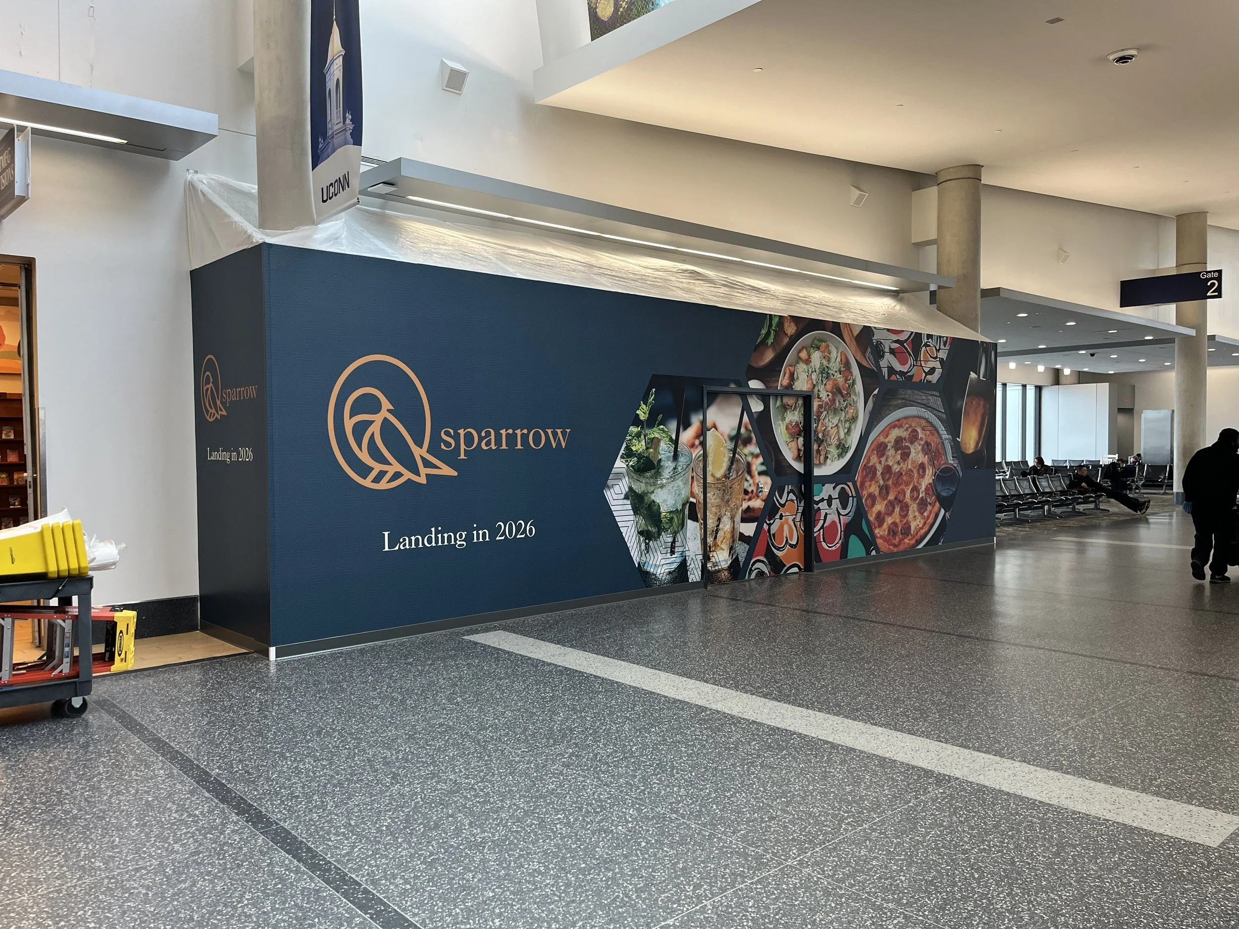 Construction wall wrap for Sparrow Pizza inside Bradley Airport.