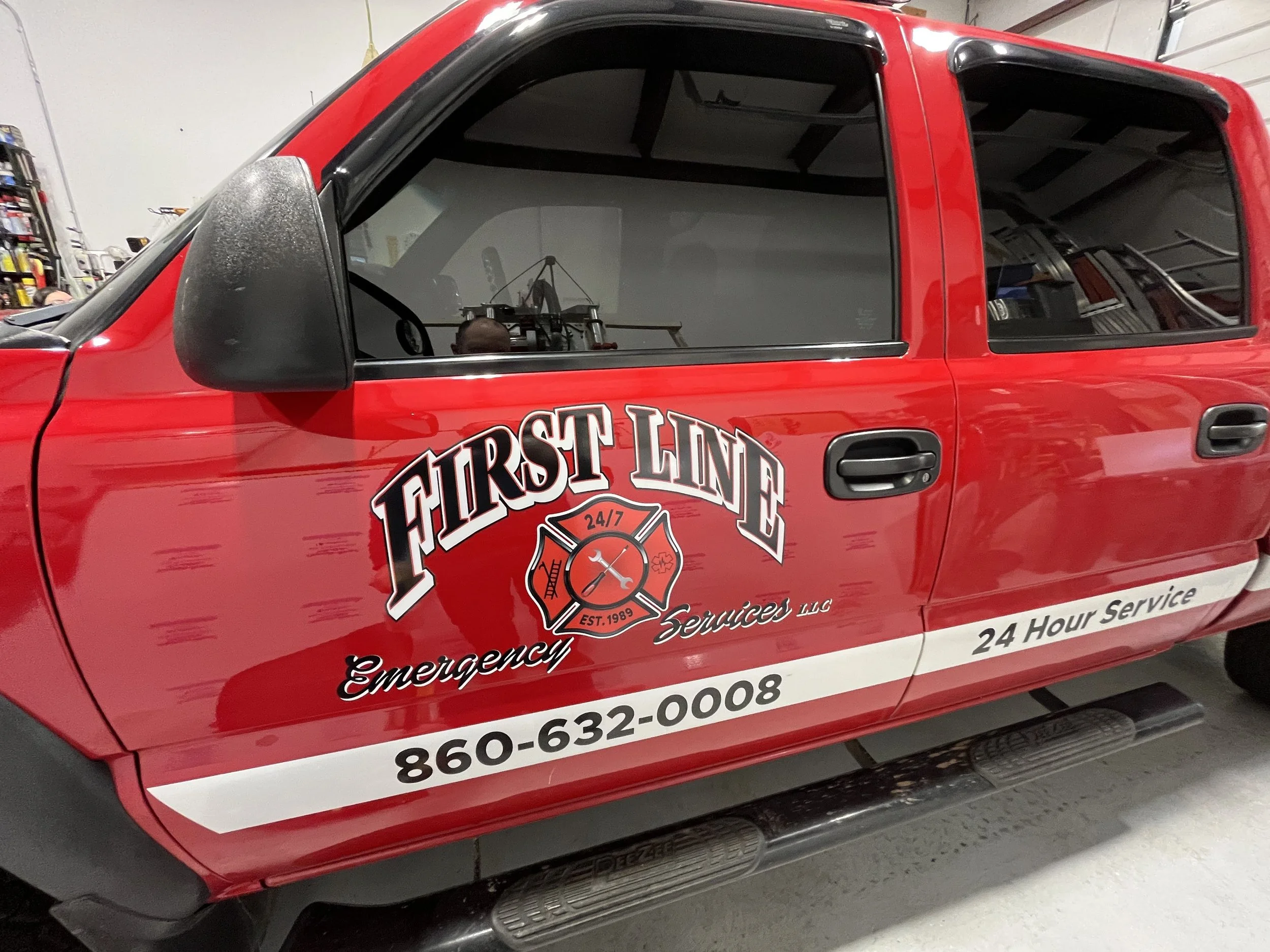 First Line Emergency Service lettering and stripe