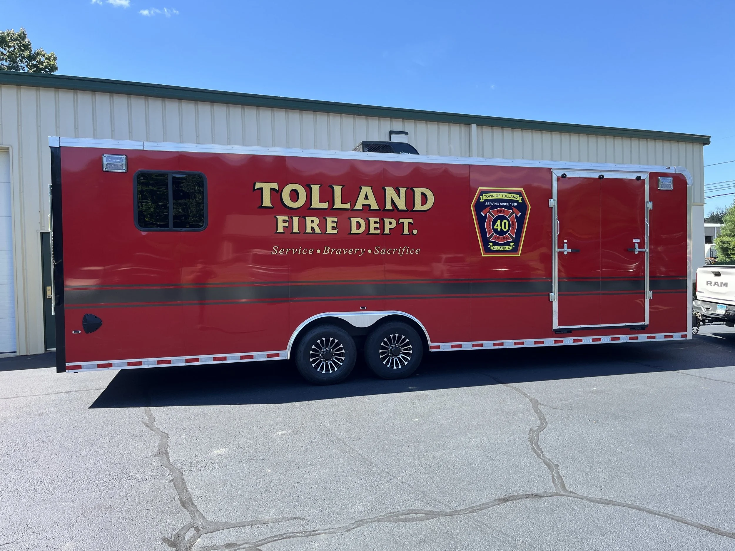 Reflective striping, large emblem graphics duplicated, and gold leaf lettering for a trailer for Tolland, CT FD