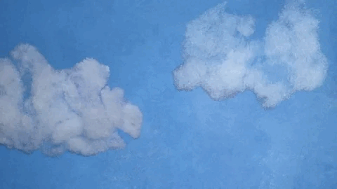Two white clouds in a blue sky.