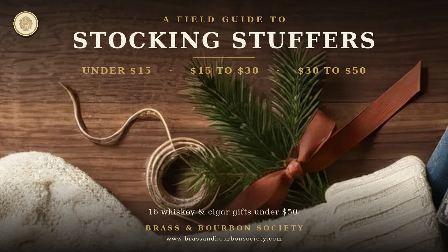 A Field Guide to Stocking Stuffers: a cream knit stocking with pine and a rust ribbon on dark wood