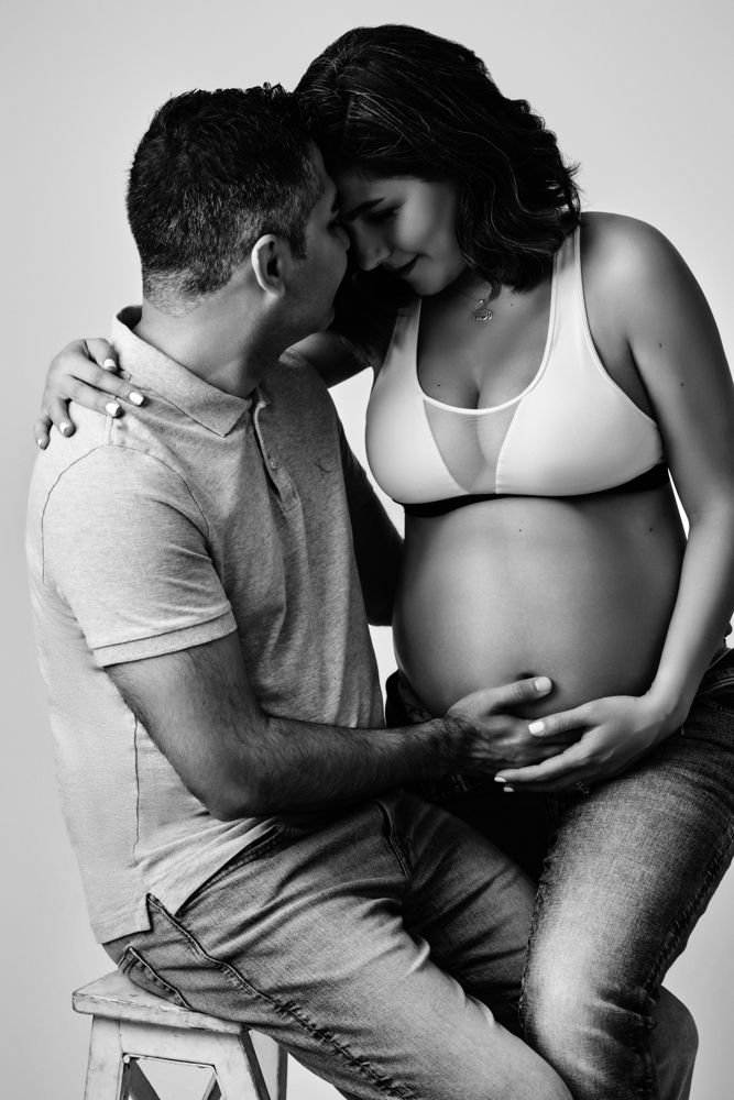 Maternity photography in Austin, Texas by Breeanna Rose Photography. Black and white maternity portrait, couple embracing.