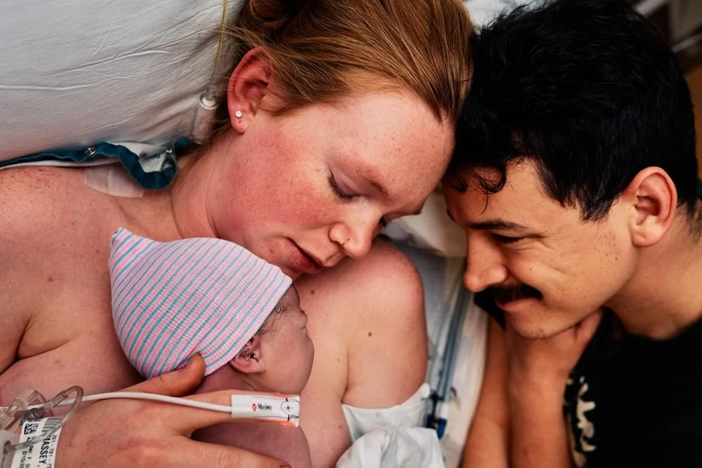 Birth photography in Austin, Texas by Breeanna Rose Photography. Parents kissing over baby.