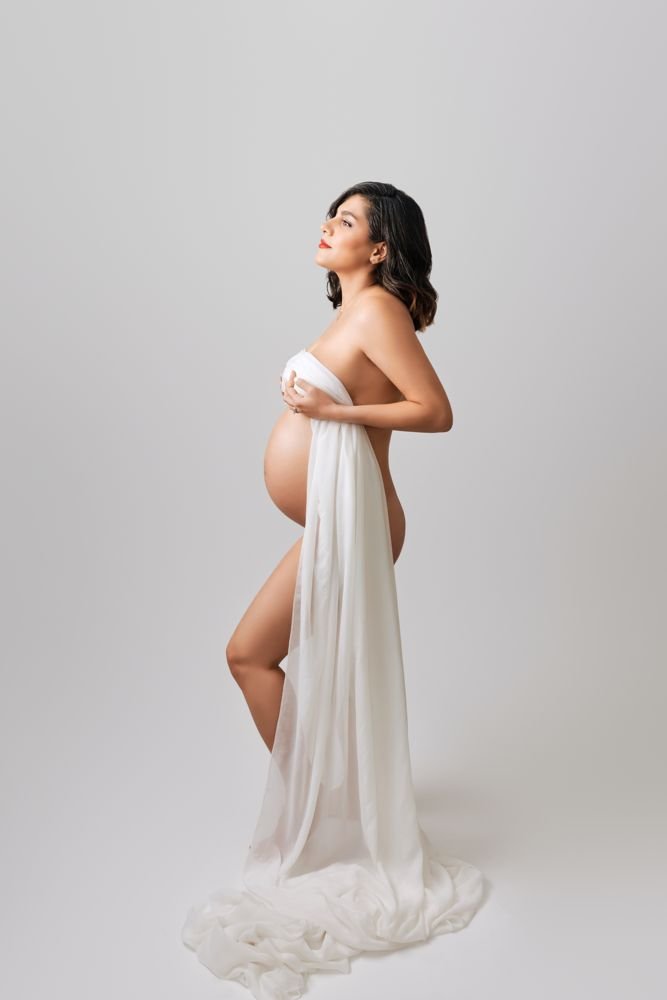 Maternity photography in Austin, Texas by Breeanna Rose Photography. Fine art maternity portrait in sheer fabric.