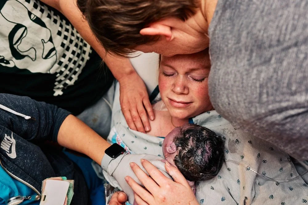 Birth photography in Austin, Texas by Breeanna Rose Photography. Mom cradling newborn, emotional.